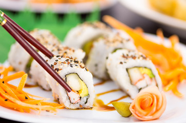 Tasty sushi rolls on a plate