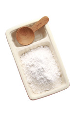 Fototapeta na wymiar white flour in ceramic cup and spoon on white background