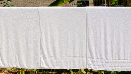 white towel on clothesline in sunny day