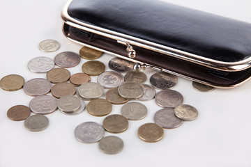 Russian coins scattered on white rydom with purse