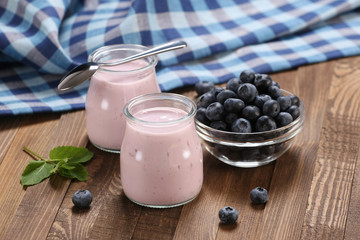 yogrt with blueberries in glass jar and Blueberries in a glass b
