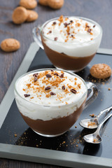 dessert with chocolate, cream and amaretti in cups, top view