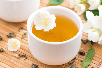 green tea with jasmine in white piala, close-up, top view