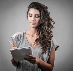 young girl taking notes