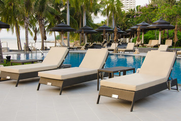 Beach chairs near swimming pool