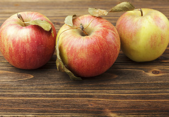 Red apples on wooden table