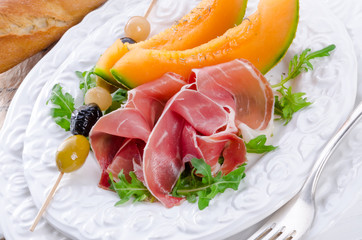 Ham with melon and olives