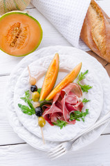 Ham with melon and olives