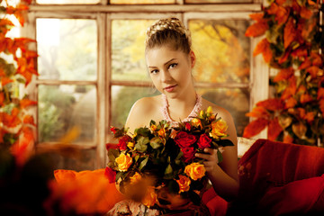 Young woman in vintage dress on autumn porch. Beauty  girl in fa