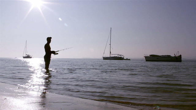 Fisherman silhouette at Ria Formosa, Algarve.