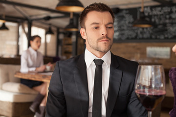 Stylish young man sitting in bar.