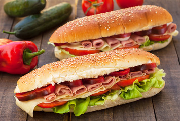 Sandwiches with ham, cheese, tomato and lettuce