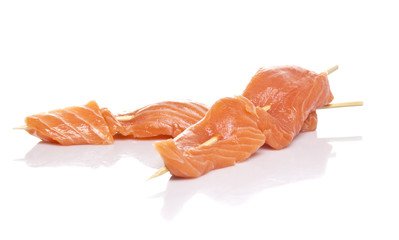 Raw salmon fillet on a skewers background