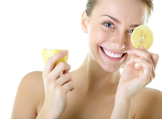 Portrait of adorable smiling girl with lemon, over white