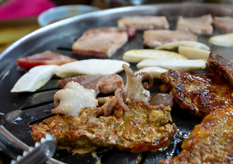Korean barbecue - meat are being cooked on stove