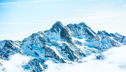 Fototapeta na wymiar Beautiful snow-capped mountains against the blue sky