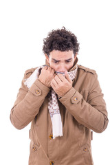 adult man in the coat covers the face with scarf
