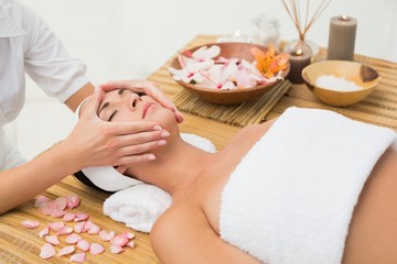 Obraz na płótnie Canvas Peaceful brunette enjoying a face massage