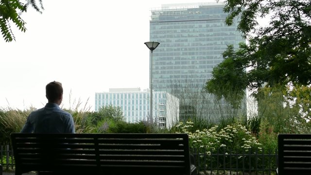 young man sitting in the park - on bench