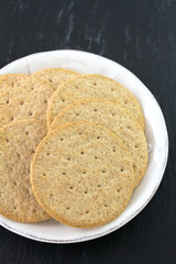 cookies on plate on black background