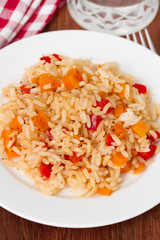rice with vegetables on plate and glass of water