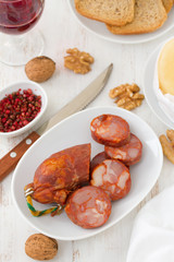 sausages on dish with wine and toasts