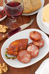 sausages on dish and glass red wine