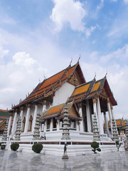 Fototapeta na wymiar Wat Suthat, the Rama I temple under cloudy sky