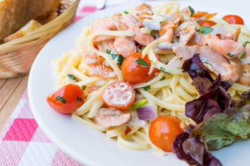 plate of pasta and smoked salmon with tomato