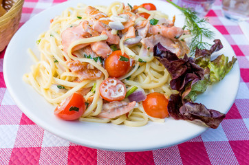 plate of pasta and smoked salmon with tomato