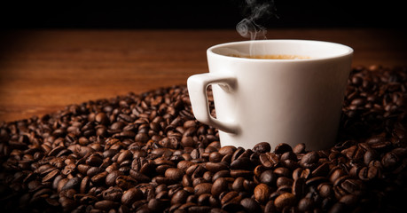 cup of black coffee with roasted coffe beans