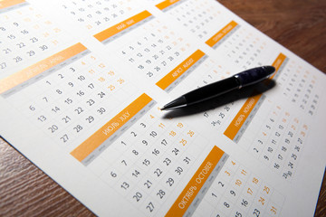 wall calendar with pen closeup