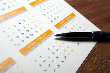 wall calendar with pen closeup