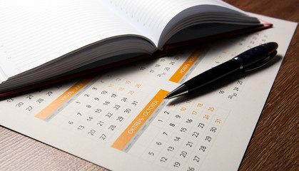 wall calendar with pen and diary closeup