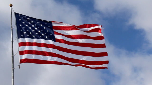 American Flag Waving against Blue Sky