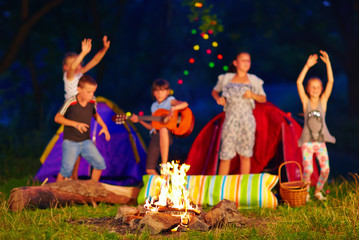 kids having fun around campfire. focus on fire