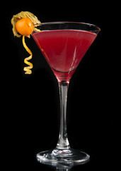 Red alcohol cosmopolitan cocktail on black background