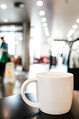 Coffee cup in coffee shop interior