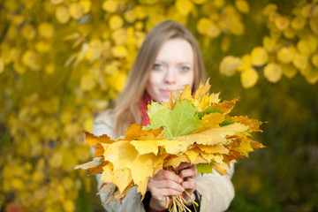 woman with autumn leaves in hand