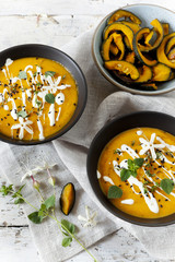 cream of pumpkin and carrot soup on bowls with sour cream