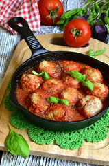 Meatballs with rice in a pan.