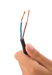 Female hand holding exposed electrical wire over white 