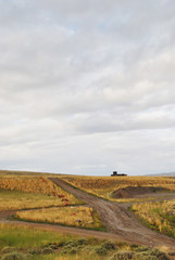 Landscape of cross of roads and hut woth cloudy sky in summer