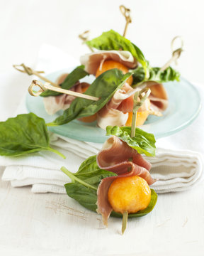 Appetizer With Melon And Prosciutto On Skewers