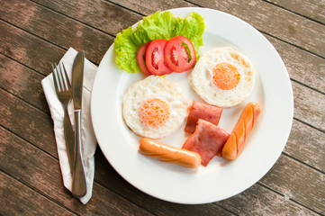 Smiles Breakfast  breakfast with fried eggs, sausages, cereal, t