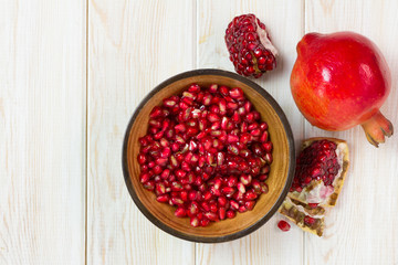 Juicy pomegranates on wood, Top view