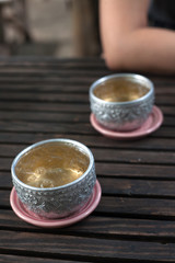 Metal water dipper on wood table