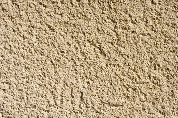 Light yellow rough plaster on wall closeup