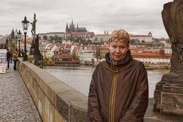 Middle-aged woman smiling on the Charles Bridge