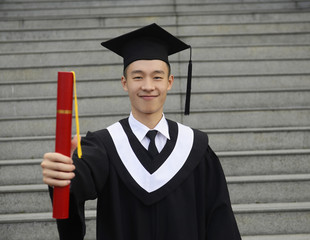 isolated studio picture from a young graduation man
